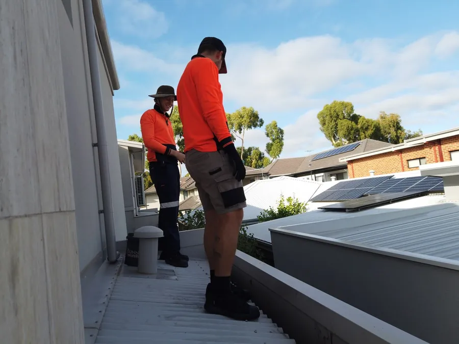 The local Perth Gutter Cleaning Pros family crew clearing gutters on a Perth roof