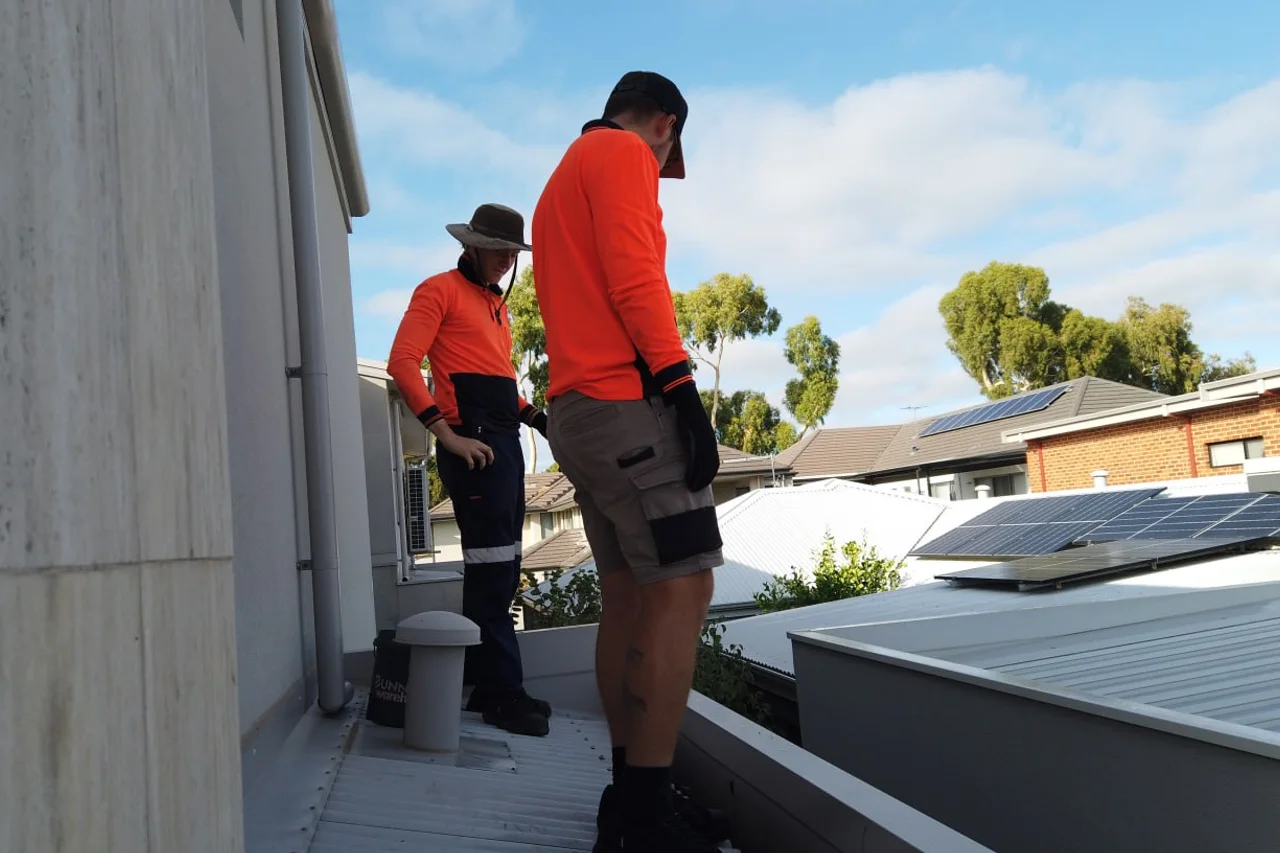 Two of the crew checking the roof and gutter line on a Perth property